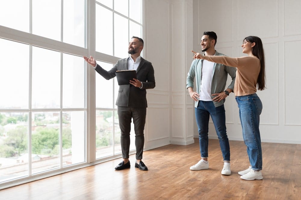 couple working with a property manager getting their rent ready for a tenant